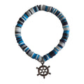 Blue, white, and dark disc bead bracelet with a silver-tone ship’s wheel charm.